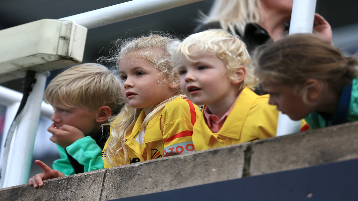 Excited young fans wait expectantly for the game to start